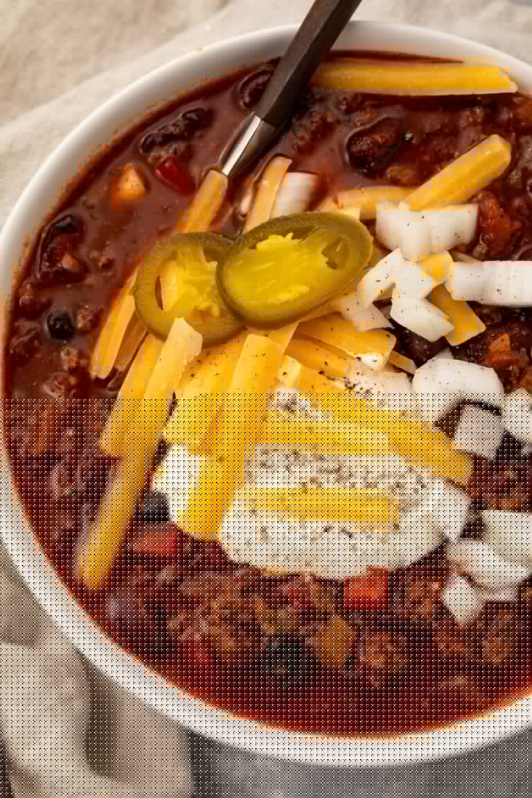 Overhead photo of nourishing slow cooker chili in a white bowl